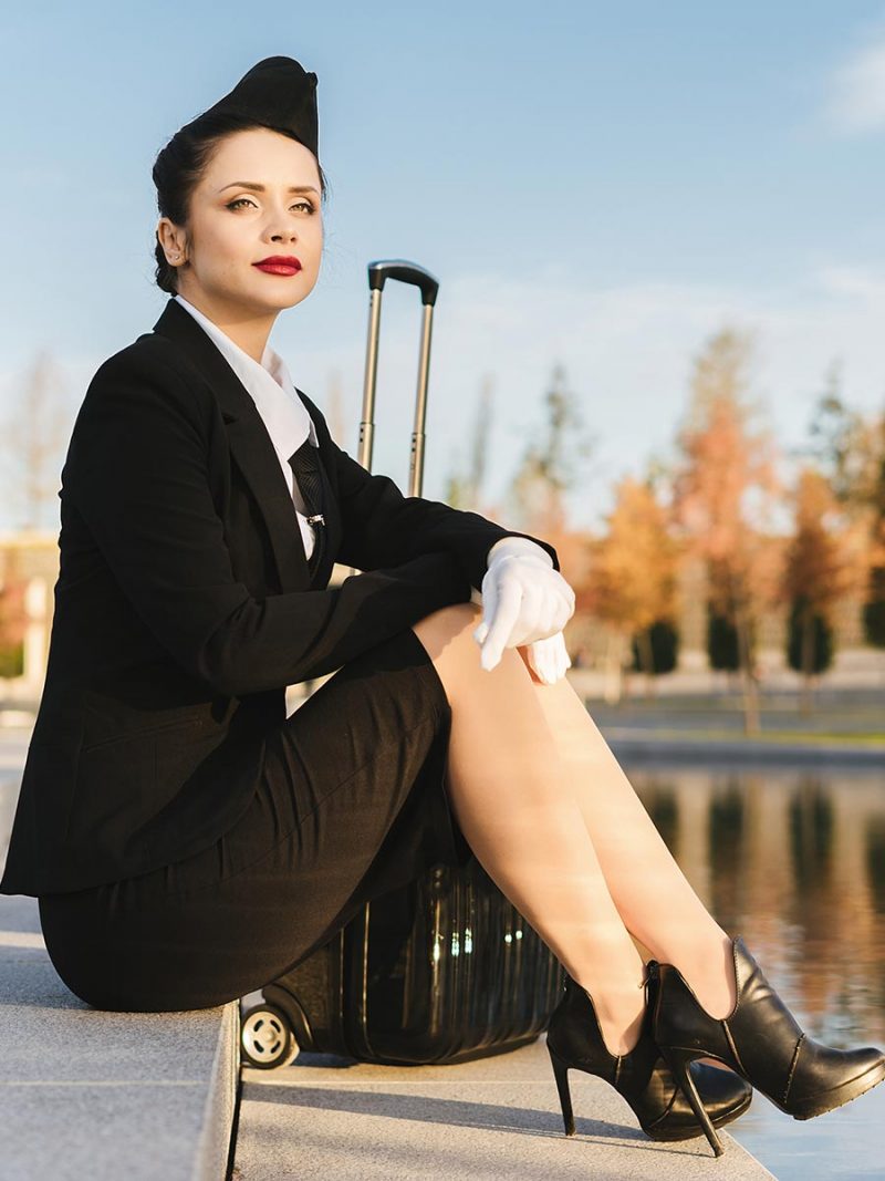Attractive confident stewardess in uniform