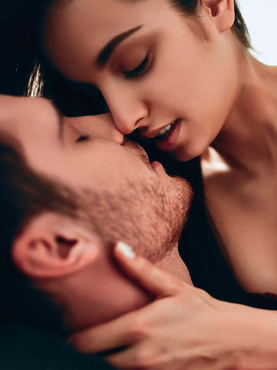 Attractive couple kissing hot and intimate during foreplay