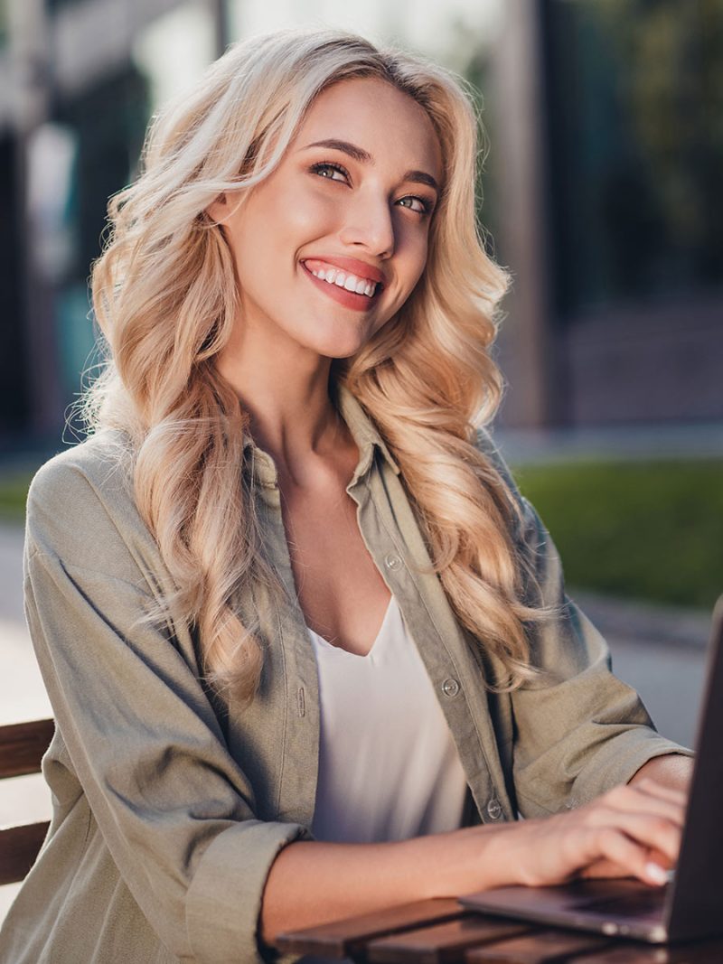 Pretty young woman sits in a cafe and chats in a single community.